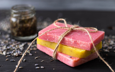 Handmade colorful natural soap on dark wood background