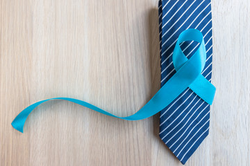 Blue ribbon symbolic for prostate cancer awareness and men's health in November month on necktie