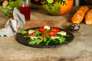 salad - arugula, cheese, tomatoes, lettuce and sesame (Healthy salad from fresh vegetables). Vegan food. Flat lay. Diet menu. Top view