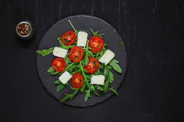 salad - arugula, cheese, tomatoes, lettuce and sesame (Healthy salad from fresh vegetables). Vegan food. Flat lay. Diet menu. Top view