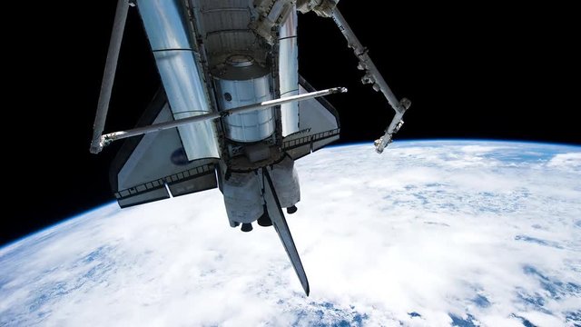 Space shuttle working on orbit seen from space station. Planet Earth seen from space. Retouched and color corrected 4k timelapse footage. Original Imagery by NASA Johnson Space Center