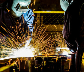 worker with protective mask welding metal