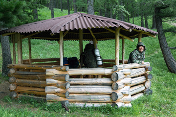 Tourist hiding from the rain and wind under a canopy. A man hides from rain and weather in a...