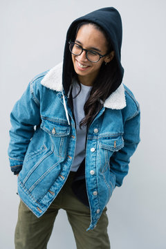 Young woman posing near wall
