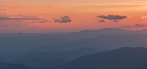 Fototapeta na wymiar Great Smoky Mountains National Park, North Carolina, USA - July 4, 2018: Mountain layers full of colorful foliage right after sunset in the Great Smoky Mountains