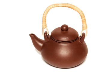 Brown clay teapot with wooden handle