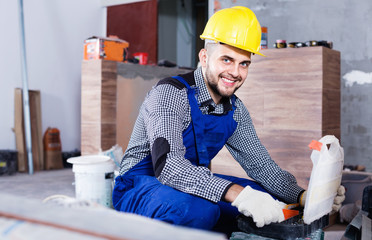 Builder is choosing tools in suitcase for work