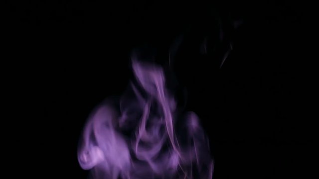 Purple Steam Rises from up. Purple smoke over a black background. Smoke slowly floating through space against black background. 4K UHD