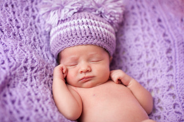 Sleeping Newborn Baby Girl in Purple Knit Hat