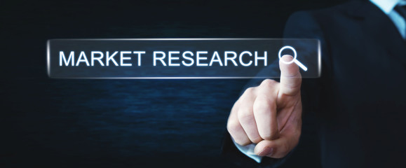 Man touching on Market Research search button. Web search concept