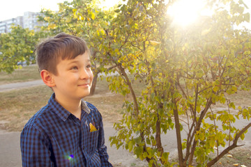 Happy boy have fun in the autumn park