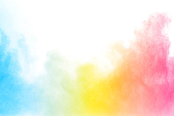 Abstract multi color powder explosion on white background.  Freeze motion of  dust  particles...
