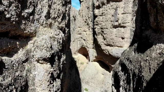 Aerial-Flying through narrow slot canyon with close in walls of dark, almost monochromatic  conglomerate material off Maple Canyon in the Sanpitch mountains of south central Utah