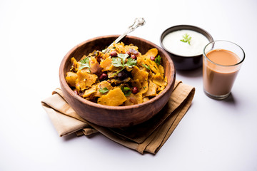 Homemade Kothu Parotta/ Paratha or Stir Fried Leftover Chapati Masala or  fodnichi poli in marathi, served in a bowl or plate with curd and hot tea. Selective focus