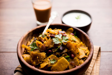 Homemade Kothu Parotta/ Paratha or Stir Fried Leftover Chapati Masala or  fodnichi poli in marathi, served in a bowl or plate with curd and hot tea. Selective focus