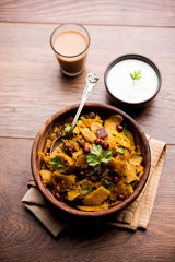 Homemade Kothu Parotta/ Paratha or Stir Fried Leftover Chapati Masala or  fodnichi poli in marathi, served in a bowl or plate with curd and hot tea. Selective focus
