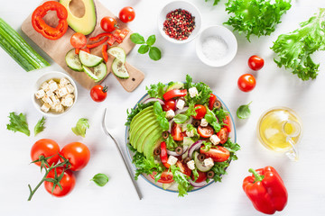 greek style avocado tomato salad with feta cheese, olives, cucumber, onion, lettuce