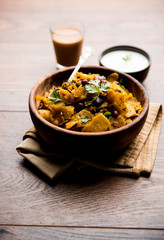 Homemade Kothu Parotta/ Paratha or Stir Fried Leftover Chapati Masala or  fodnichi poli in marathi, served in a bowl or plate with curd and hot tea. Selective focus