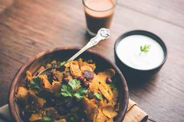 Homemade Kothu Parotta/ Paratha or Stir Fried Leftover Chapati Masala or  fodnichi poli in marathi, served in a bowl or plate with curd and hot tea. Selective focus