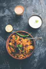 Homemade Kothu Parotta/ Paratha or Stir Fried Leftover Chapati Masala or  fodnichi poli in marathi, served in a bowl or plate with curd and hot tea. Selective focus