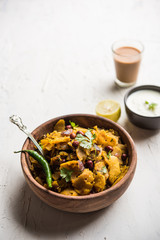 Homemade Kothu Parotta/ Paratha or Stir Fried Leftover Chapati Masala or  fodnichi poli in marathi, served in a bowl or plate with curd and hot tea. Selective focus