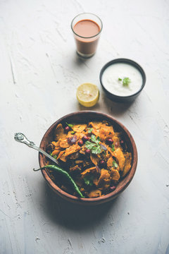 Homemade Kothu Parotta/ Paratha or Stir Fried Leftover Chapati Masala or  fodnichi poli in marathi, served in a bowl or plate with curd and hot tea. Selective focus