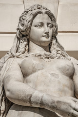 Statue of sensual busty and puffy renaissance era woman in Vienna, Austria, details, closeup