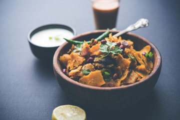 Homemade Kothu Parotta/ Paratha or Stir Fried Leftover Chapati Masala or  fodnichi poli in marathi, served in a bowl or plate with curd and hot tea. Selective focus