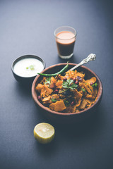 Homemade Kothu Parotta/ Paratha or Stir Fried Leftover Chapati Masala or  fodnichi poli in marathi, served in a bowl or plate with curd and hot tea. Selective focus