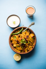 Homemade Kothu Parotta/ Paratha or Stir Fried Leftover Chapati Masala or  fodnichi poli in marathi, served in a bowl or plate with curd and hot tea. Selective focus