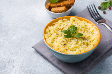 Mashed potatoes with herbs, croutons and lemon in a plate on napkins.