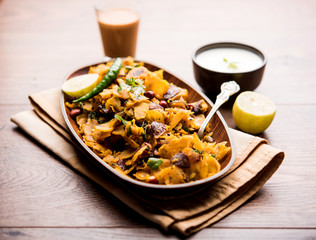 Homemade Kothu Parotta/ Paratha or Stir Fried Leftover Chapati Masala or  fodnichi poli in marathi, served in a bowl or plate with curd and hot tea. Selective focus