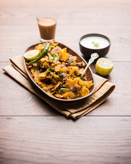 Homemade Kothu Parotta/ Paratha or Stir Fried Leftover Chapati Masala or  fodnichi poli in marathi, served in a bowl or plate with curd and hot tea. Selective focus