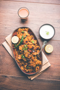 Homemade Kothu Parotta/ Paratha or Stir Fried Leftover Chapati Masala or  fodnichi poli in marathi, served in a bowl or plate with curd and hot tea. Selective focus