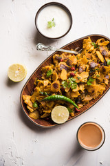 Homemade Kothu Parotta/ Paratha or Stir Fried Leftover Chapati Masala or  fodnichi poli in marathi, served in a bowl or plate with curd and hot tea. Selective focus