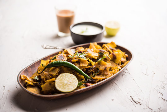 Homemade Kothu Parotta/ Paratha or Stir Fried Leftover Chapati Masala or  fodnichi poli in marathi, served in a bowl or plate with curd and hot tea. Selective focus