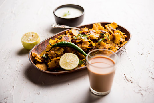 Homemade Kothu Parotta/ Paratha or Stir Fried Leftover Chapati Masala or  fodnichi poli in marathi, served in a bowl or plate with curd and hot tea. Selective focus