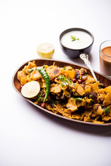 Homemade Kothu Parotta/ Paratha or Stir Fried Leftover Chapati Masala or  fodnichi poli in marathi, served in a bowl or plate with curd and hot tea. Selective focus