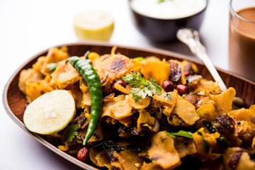 Homemade Kothu Parotta/ Paratha or Stir Fried Leftover Chapati Masala or  fodnichi poli in marathi, served in a bowl or plate with curd and hot tea. Selective focus
