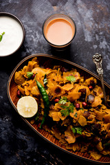Homemade Kothu Parotta/ Paratha or Stir Fried Leftover Chapati Masala or  fodnichi poli in marathi, served in a bowl or plate with curd and hot tea. Selective focus