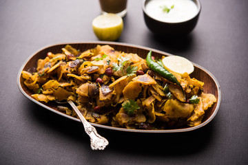 Homemade Kothu Parotta/ Paratha or Stir Fried Leftover Chapati Masala or  fodnichi poli in marathi, served in a bowl or plate with curd and hot tea. Selective focus