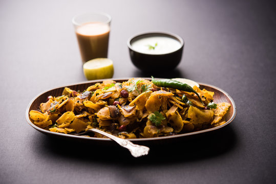 Homemade Kothu Parotta/ Paratha or Stir Fried Leftover Chapati Masala or  fodnichi poli in marathi, served in a bowl or plate with curd and hot tea. Selective focus