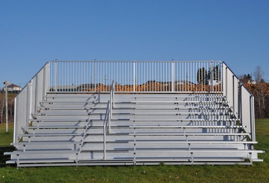 Front view of portable steel bleachers on the field 