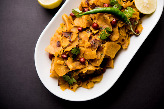 Homemade Kothu Parotta/ Paratha or Stir Fried Leftover Chapati Masala or  fodnichi poli in marathi, served in a bowl or plate with curd and hot tea. Selective focus