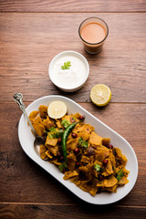 Homemade Kothu Parotta/ Paratha or Stir Fried Leftover Chapati Masala or  fodnichi poli in marathi, served in a bowl or plate with curd and hot tea. Selective focus