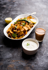 Homemade Kothu Parotta/ Paratha or Stir Fried Leftover Chapati Masala or  fodnichi poli in marathi, served in a bowl or plate with curd and hot tea. Selective focus