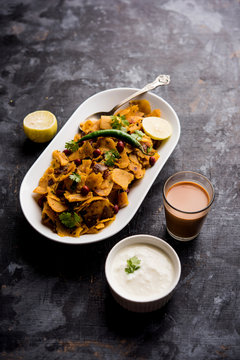 Homemade Kothu Parotta/ Paratha or Stir Fried Leftover Chapati Masala or  fodnichi poli in marathi, served in a bowl or plate with curd and hot tea. Selective focus