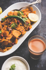 Homemade Kothu Parotta/ Paratha or Stir Fried Leftover Chapati Masala or  fodnichi poli in marathi, served in a bowl or plate with curd and hot tea. Selective focus