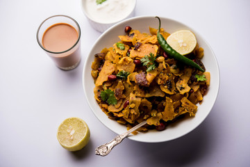 Homemade Kothu Parotta/ Paratha or Stir Fried Leftover Chapati Masala or  fodnichi poli in marathi, served in a bowl or plate with curd and hot tea. Selective focus