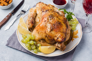 Baked chicken, mashed potatoes and wine glasses for dinner on the festive table.
